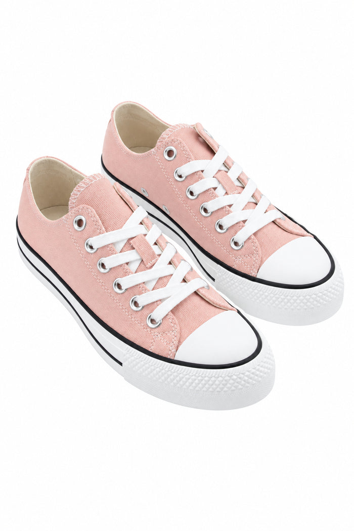 Pair of pink sneakers with white laces 