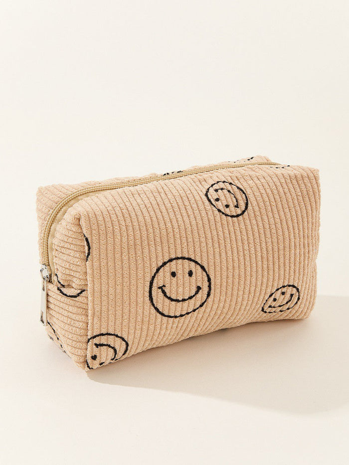 Beige textured pouch with smiley face patterns on a white background