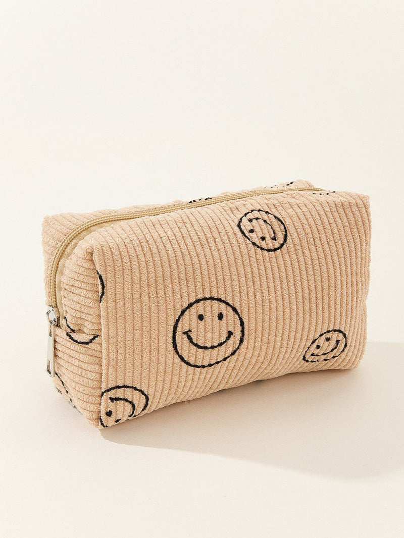 Beige textured pouch with smiley face patterns on a white background