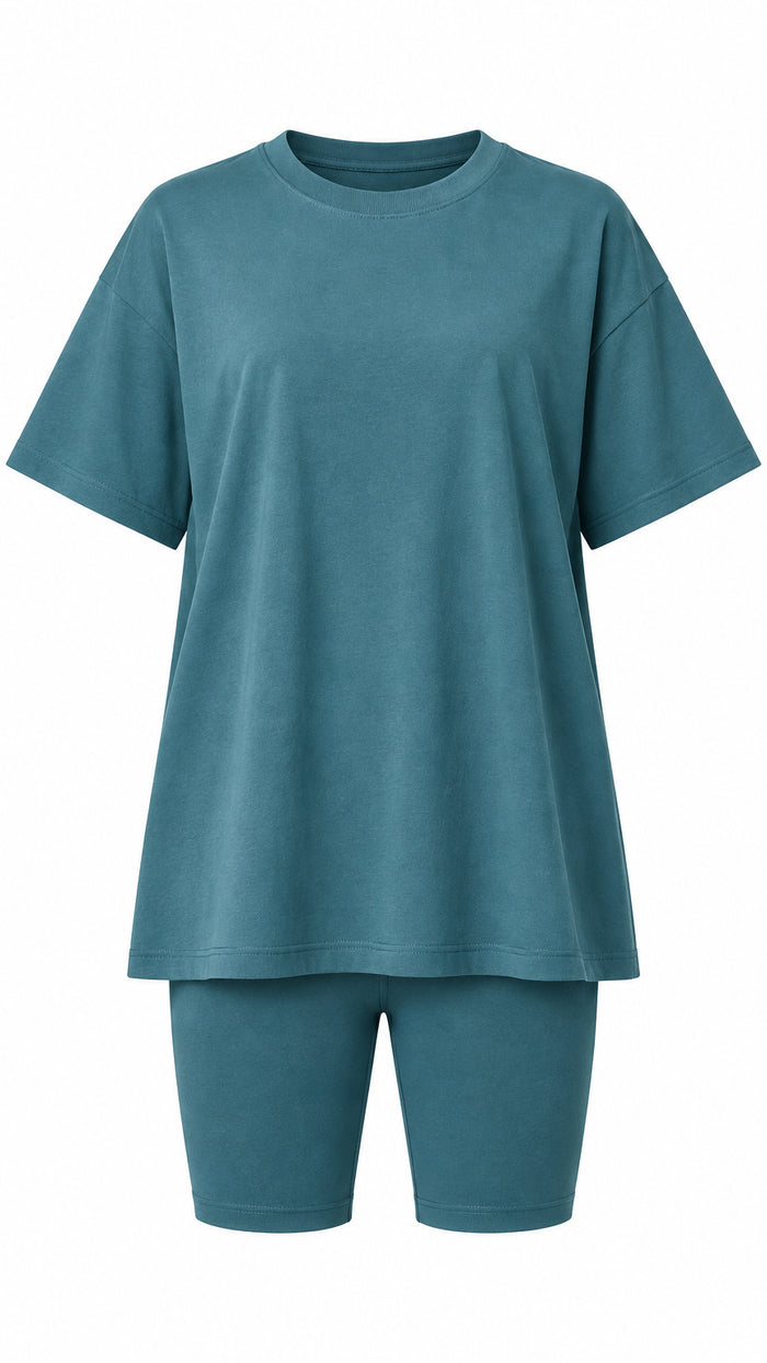 A matching two-piece lounge set consisting of an oversized short-sleeve top and fitted biker shorts in a muted teal green color